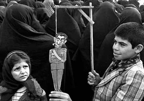pictory: Boy Hangs paper cartoon effigy of Shah  (1979) 